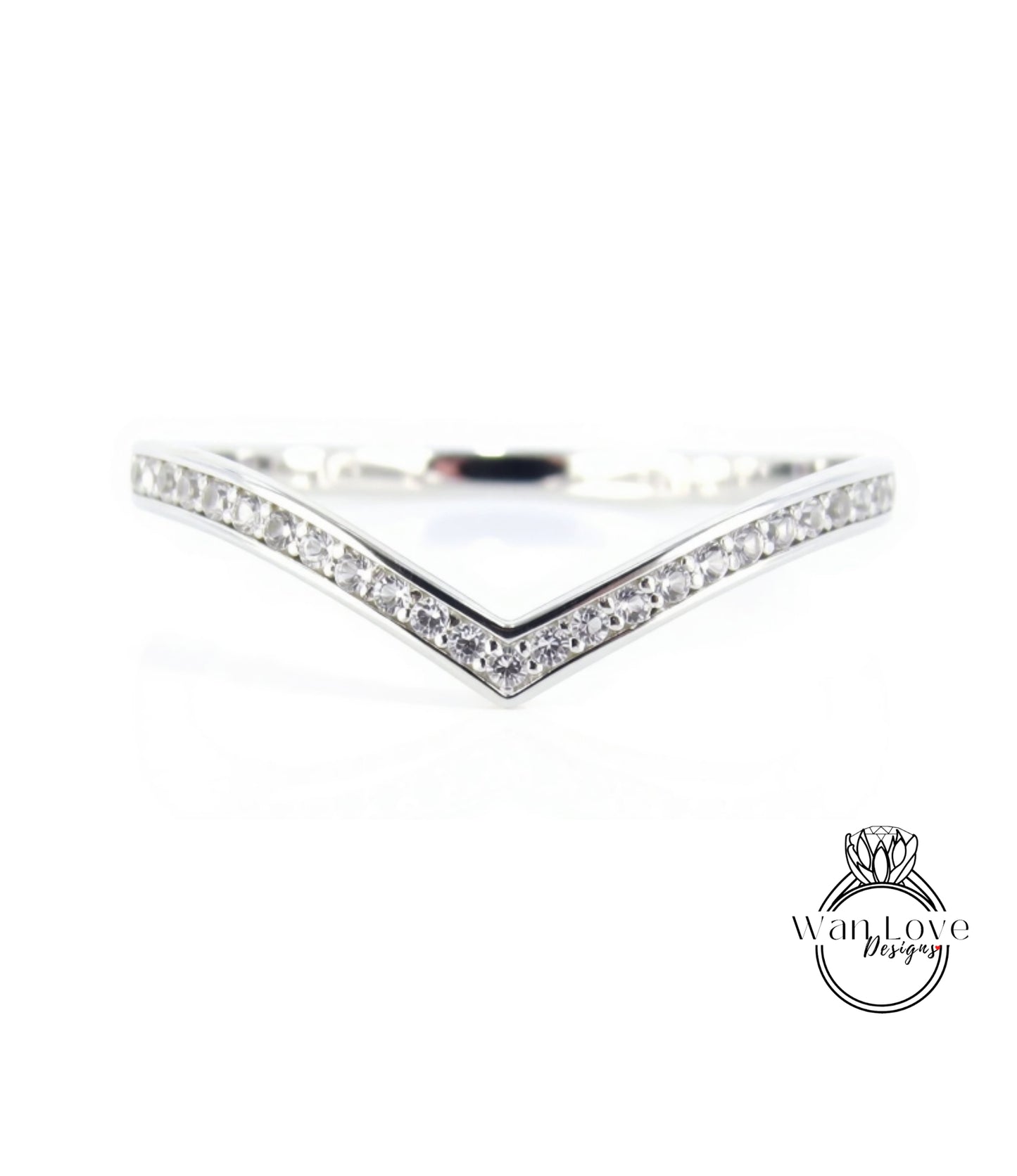 A silver ring with a v-shaped band and small diamonds set in it.