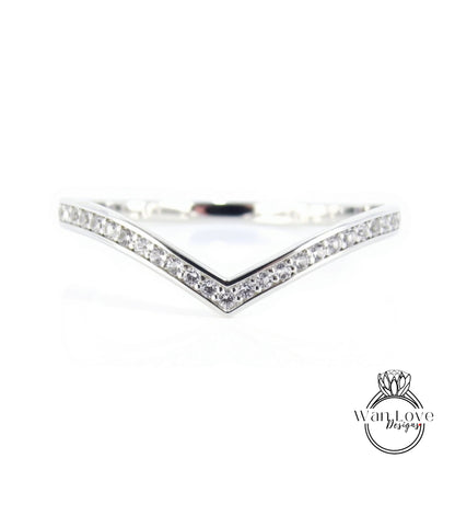 A silver ring with a v-shaped band and small diamonds set in it.