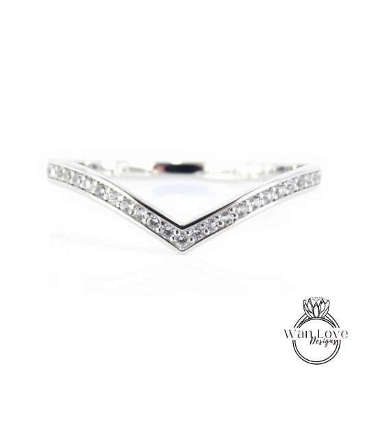 A silver ring with a v-shaped band and small diamonds set in it.