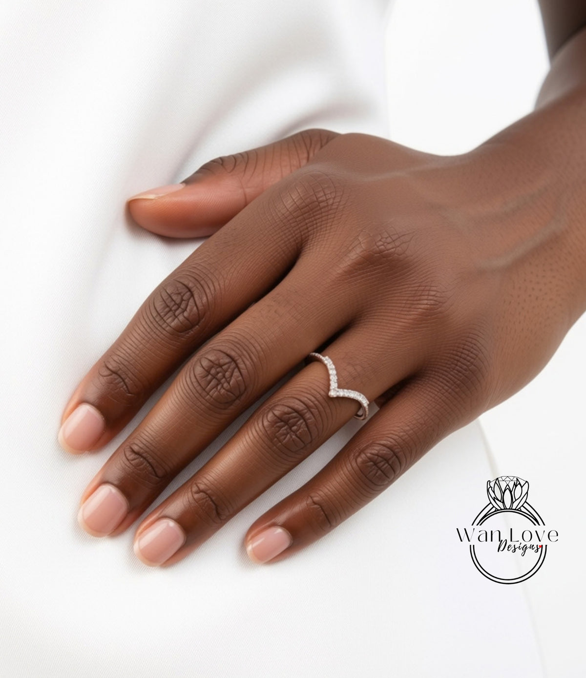 A close-up of a hand wearing a diamond ring on the ring finger.