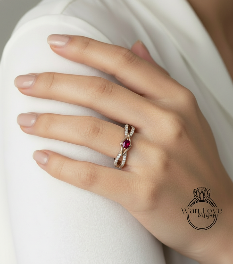 A close-up of a person's hand wearing a gold ring with a red gemstone.