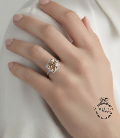 A close-up of a hand wearing a diamond engagement ring with a large, round-cut diamond set in a halo of smaller diamonds.