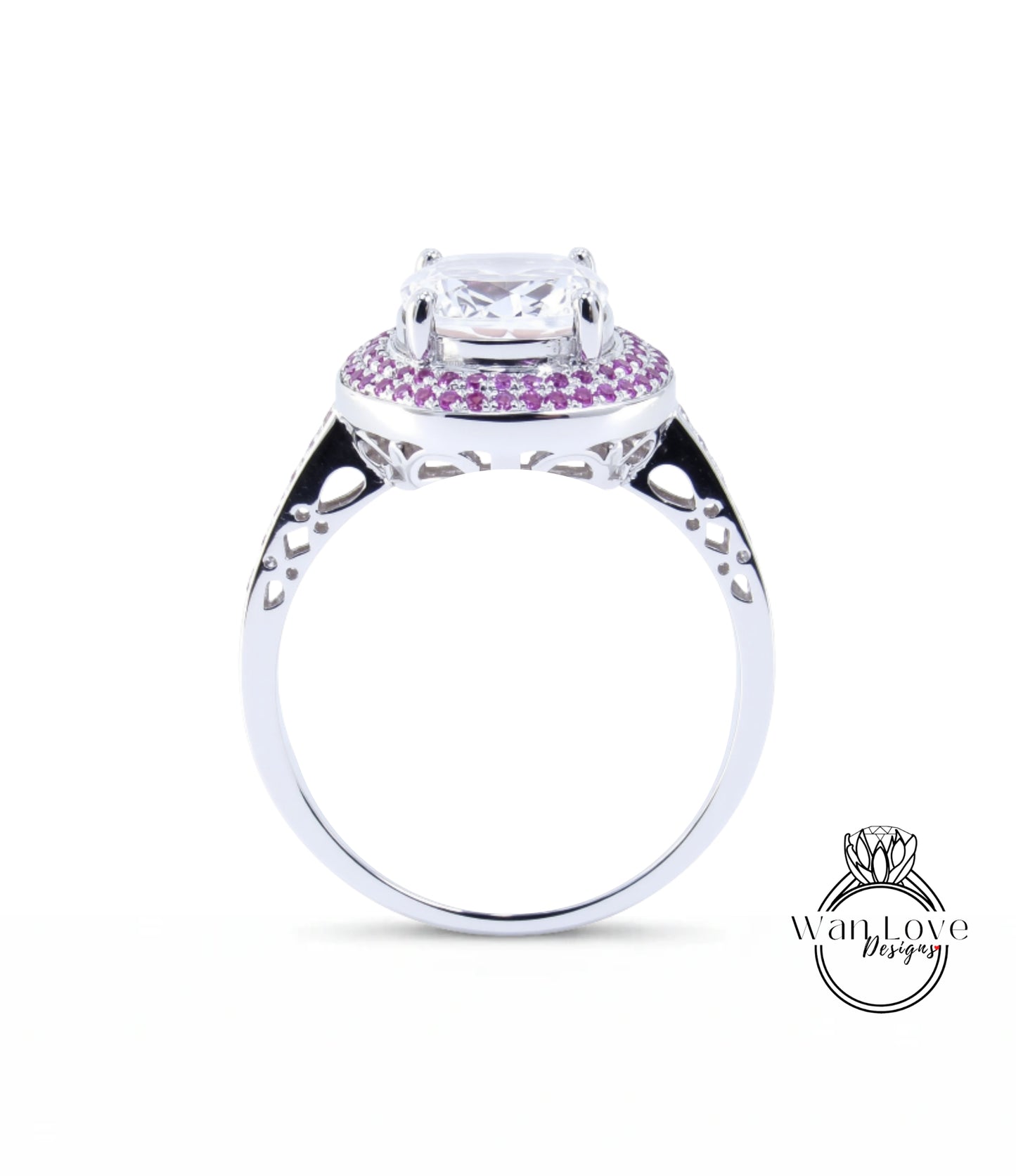 A silver ring with a large central gemstone surrounded by smaller gemstones, and a decorative band with a floral pattern.