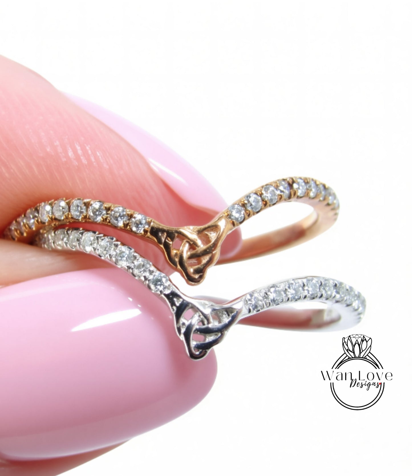 A close-up of a person's hand wearing two rings, one with a gold band and the other with a silver band, both adorned with small diamonds.