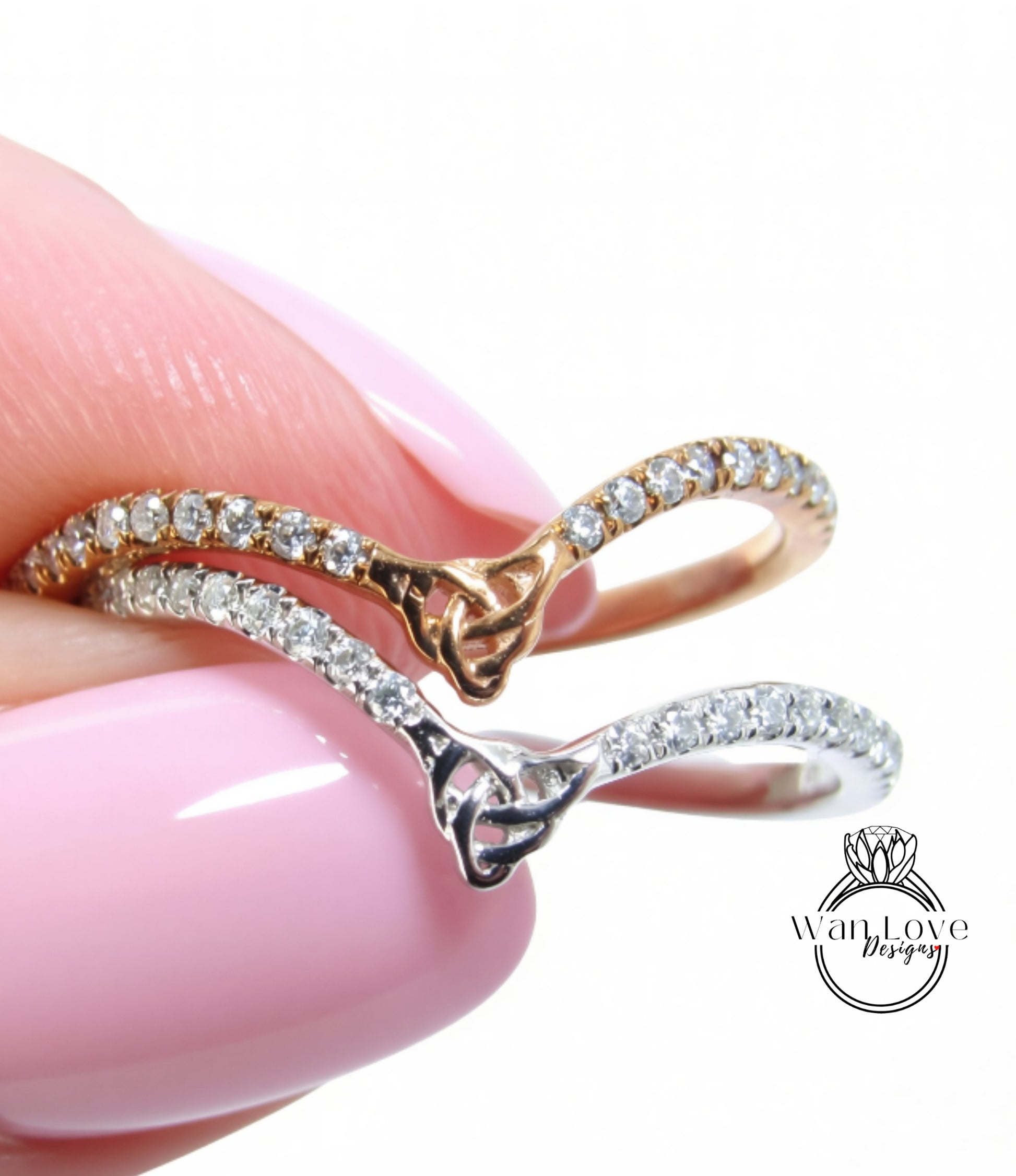 A close-up of a person's hand wearing two rings, one with a gold band and the other with a silver band, both adorned with small diamonds.