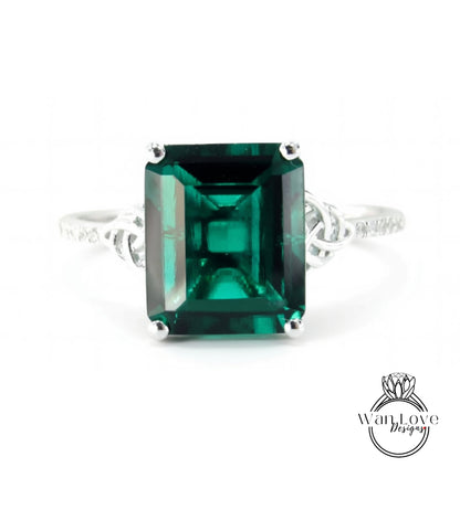 A large, green gemstone ring with a silver band.