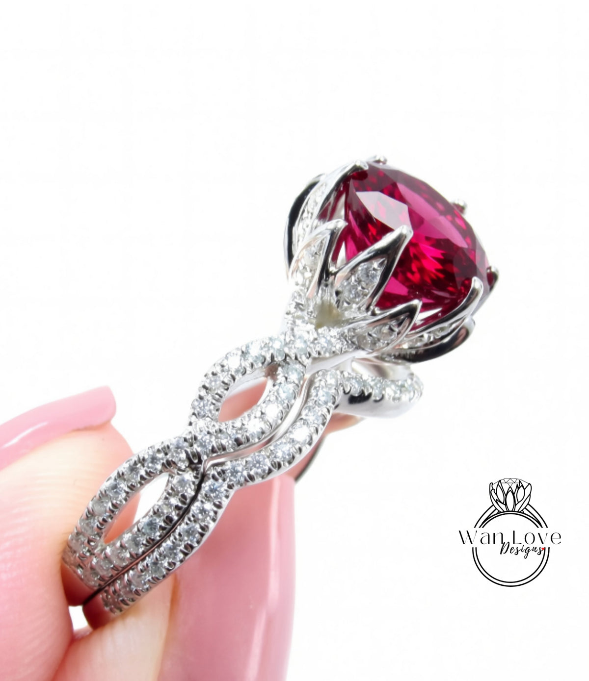 A close-up of a person's hand holding a large, ornate ring with a large, red gemstone.