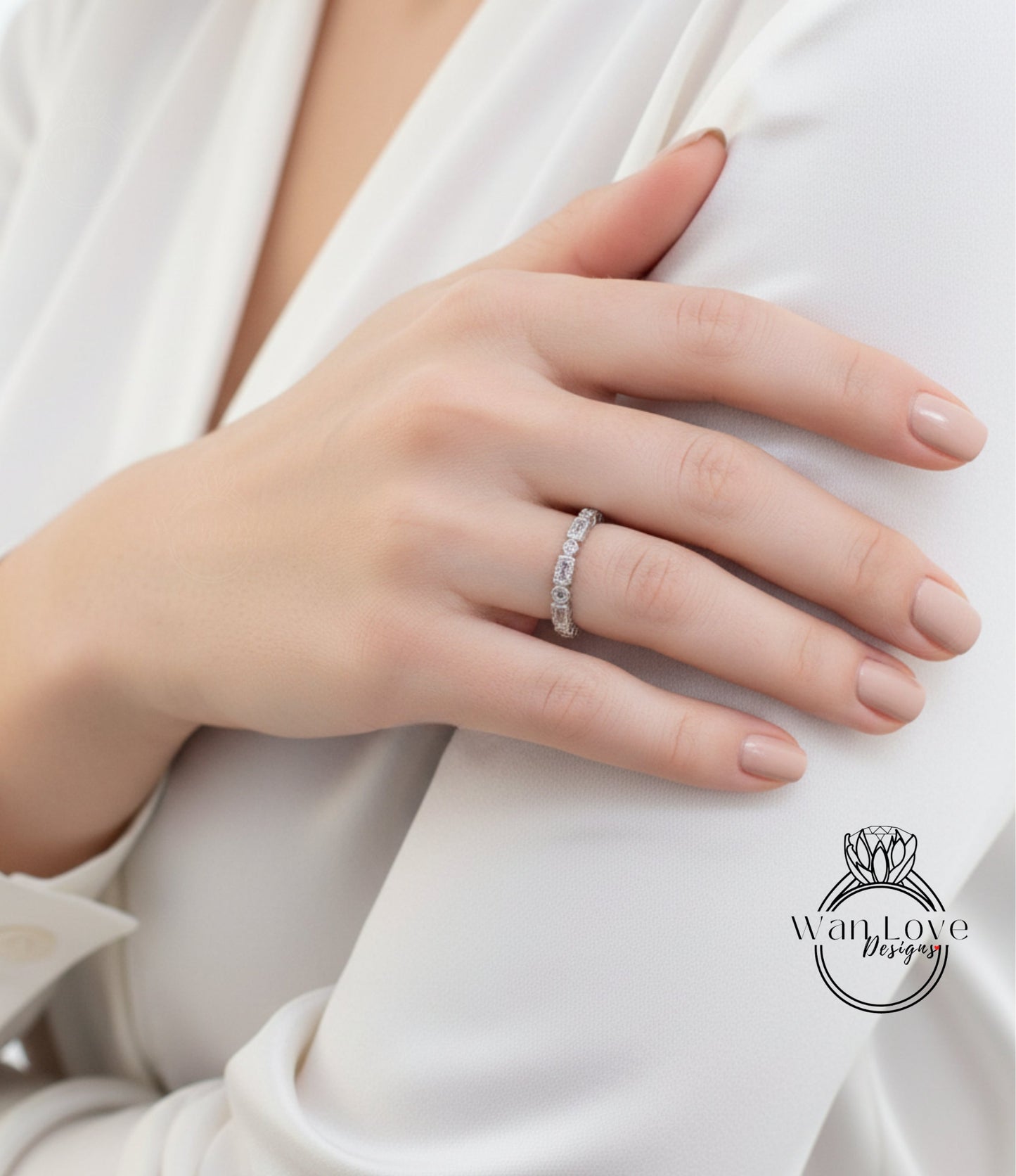 A close-up of a person's hand wearing a diamond ring on the ring finger.