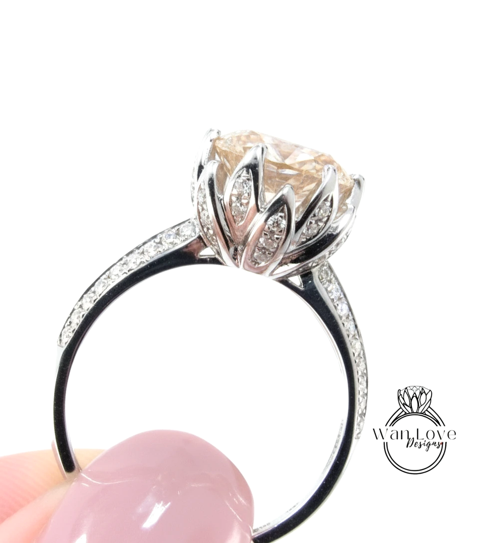 A close-up of a silver ring with a large, round diamond set in the center, surrounded by smaller diamonds.