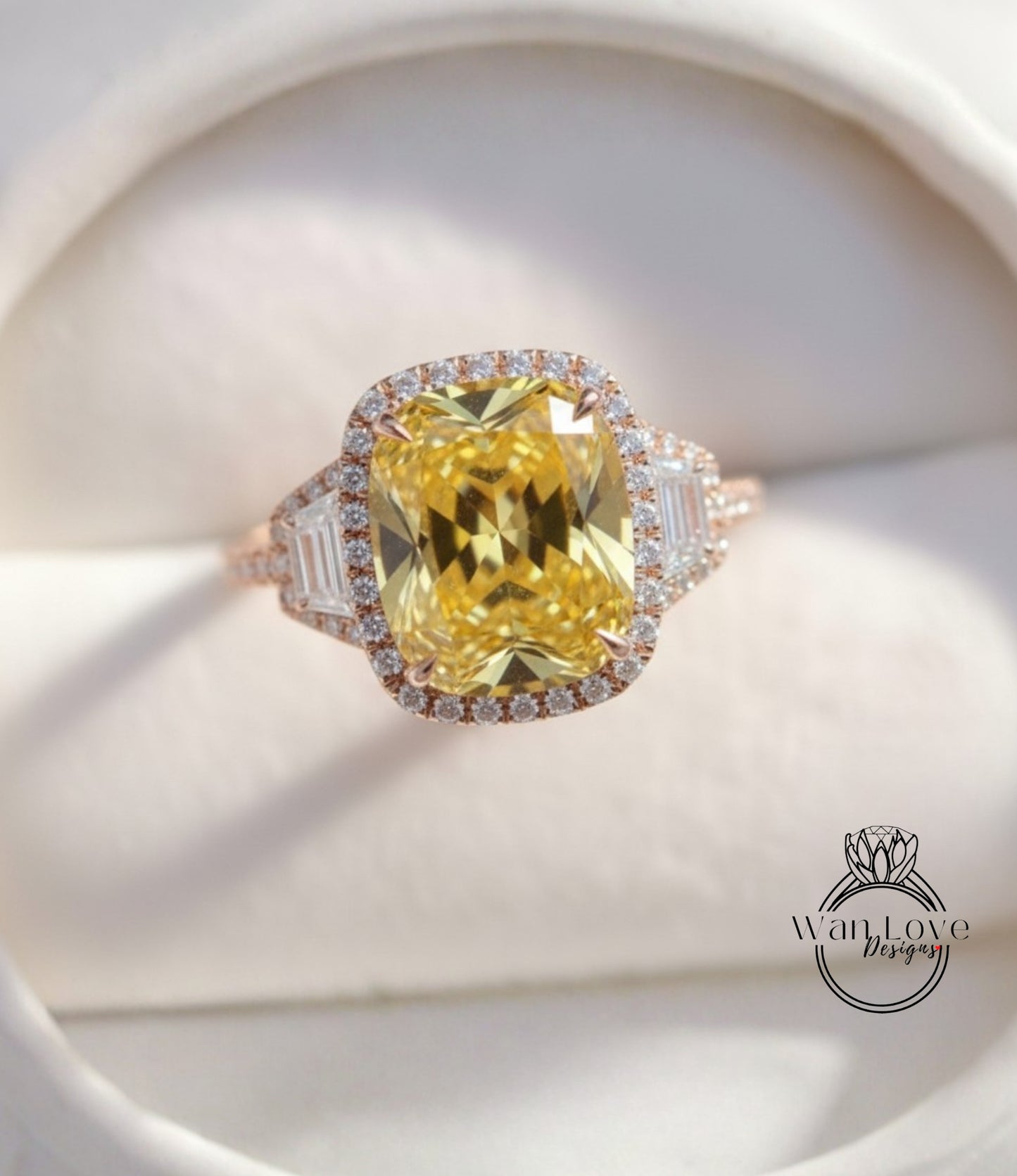 A large yellow diamond ring with a halo of smaller diamonds around the center stone, displayed on a white background.