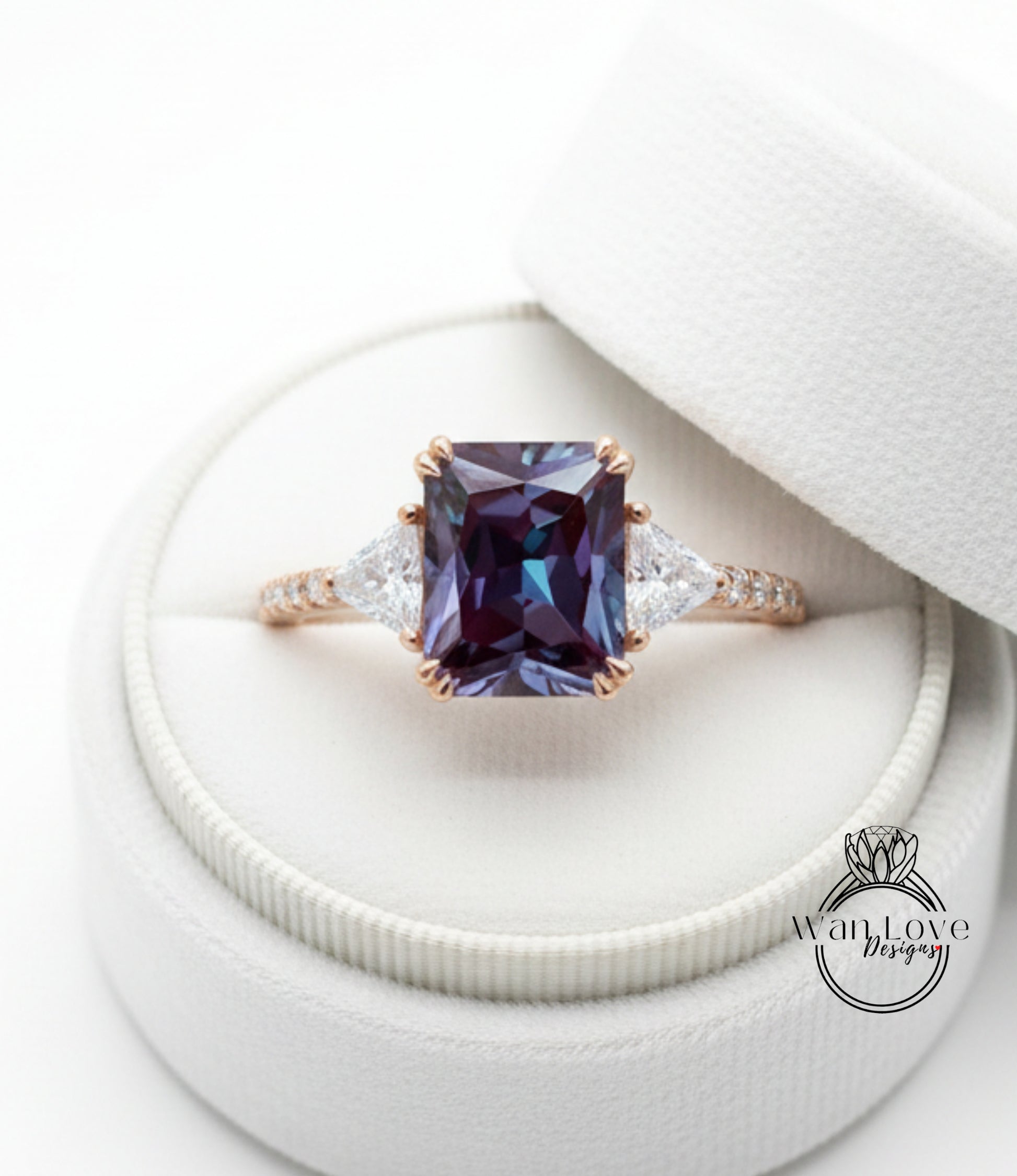 A close-up view of a diamond engagement ring placed in a white jewelry box.