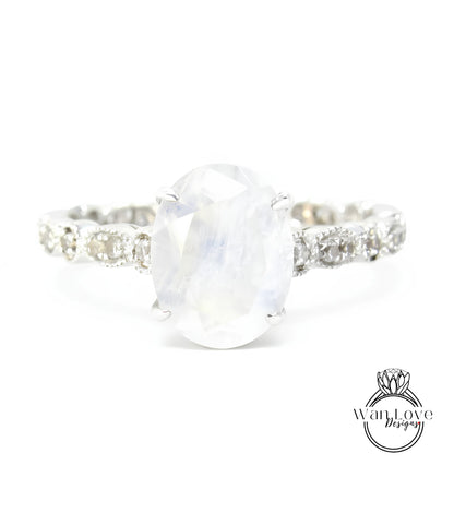 A close-up view of a silver ring with a large oval-shaped stone set in the center.