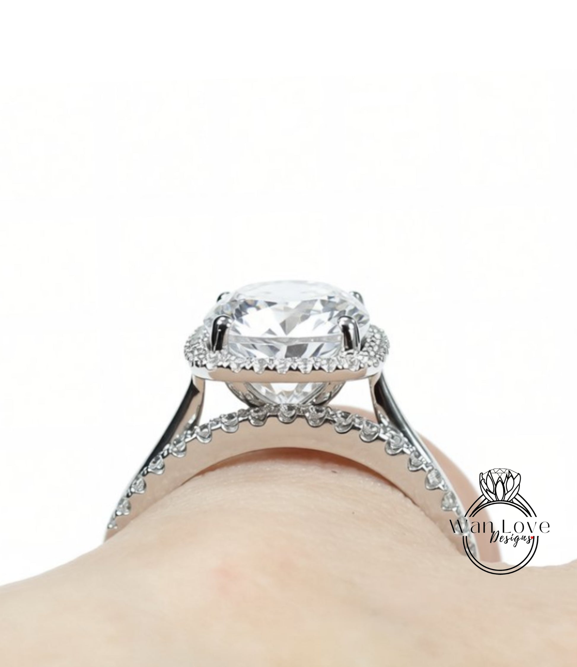 A close-up view of a large, sparkling diamond engagement ring on a person's hand.