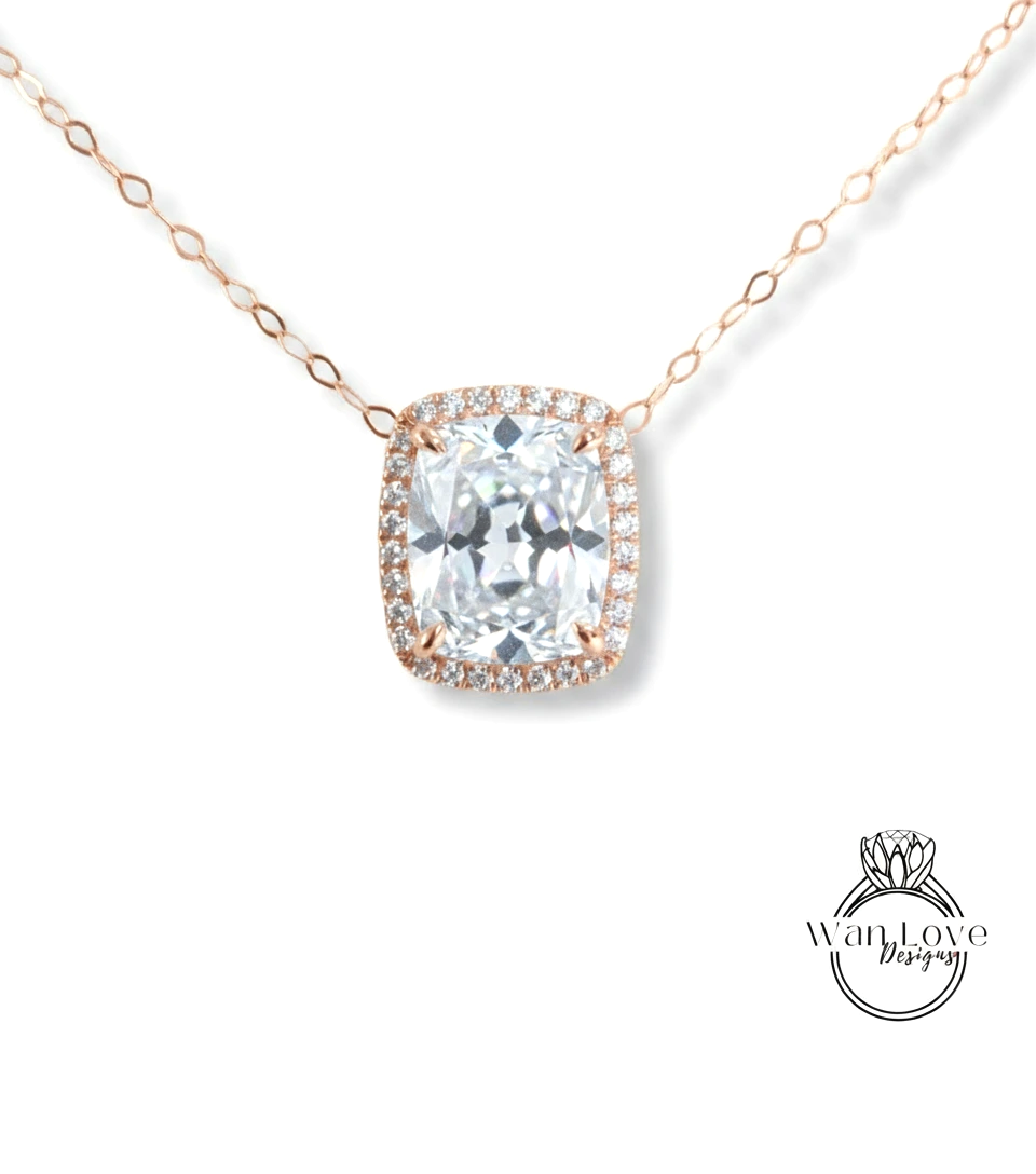 A necklace with a large, clear gemstone pendant, likely a diamond, surrounded by a halo of smaller diamonds.