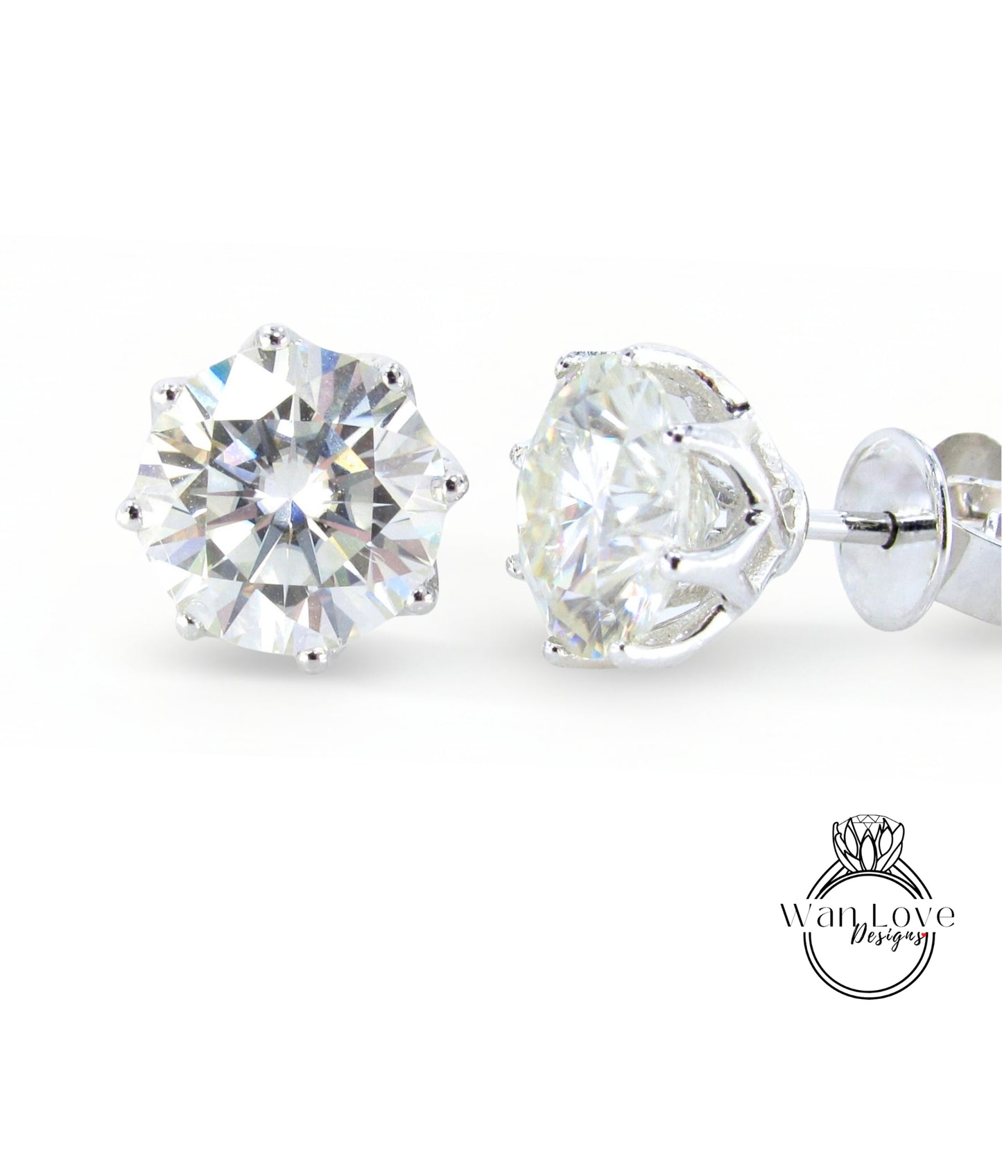 A pair of elegant diamond earrings with a large, brilliant-cut diamond set in a silver metal frame.