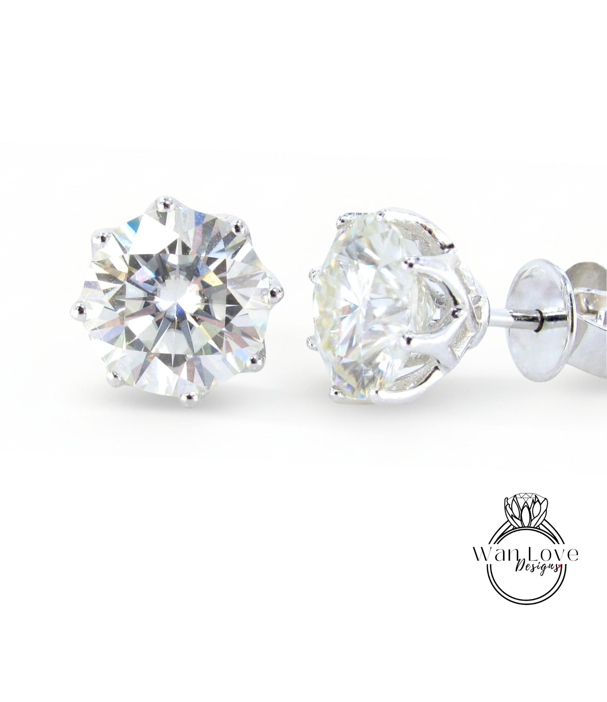 A pair of elegant diamond earrings with a large, brilliant-cut diamond set in a silver metal frame.