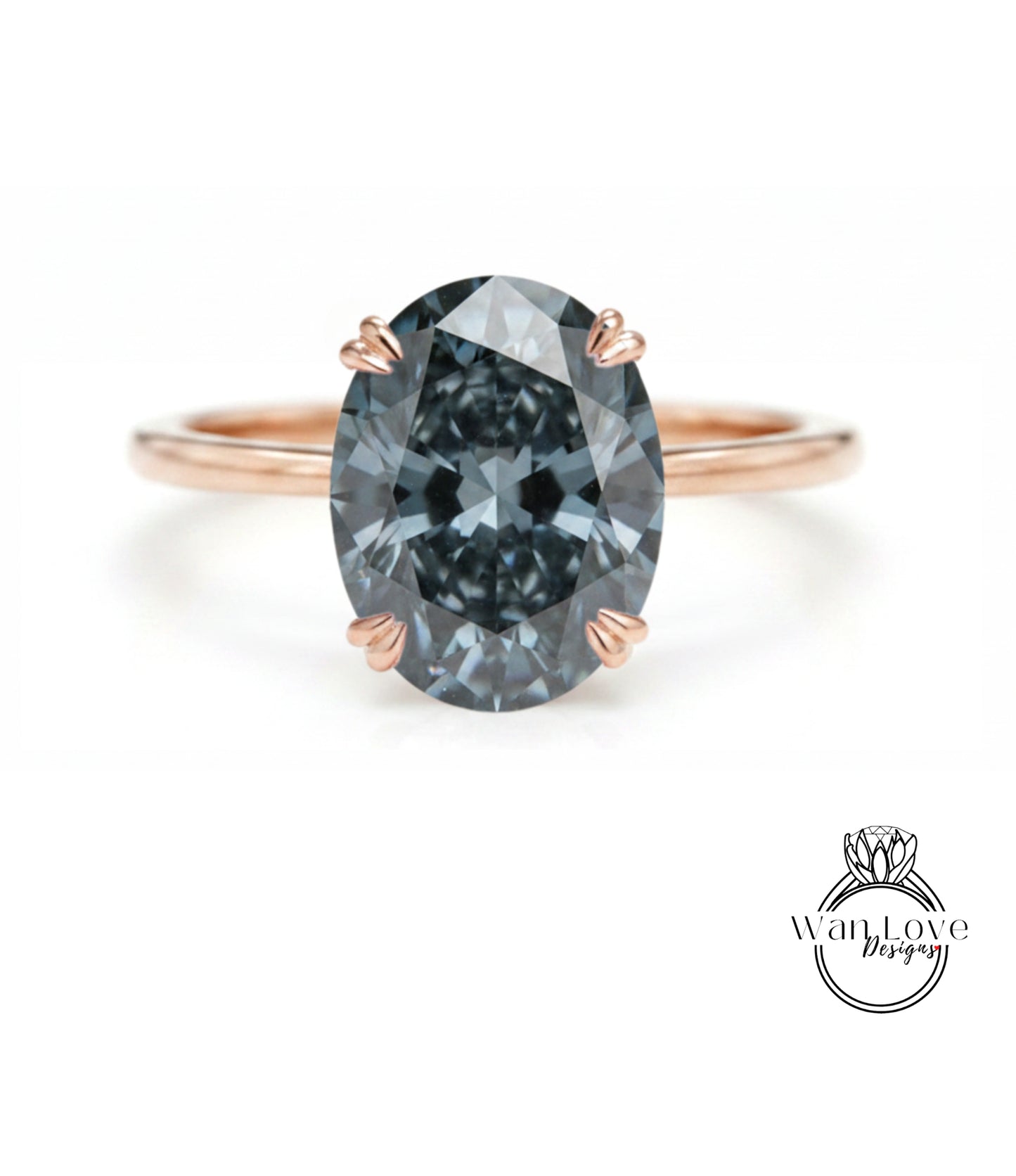 A close-up of a rose gold ring with a large, dark blue diamond as the centerpiece.