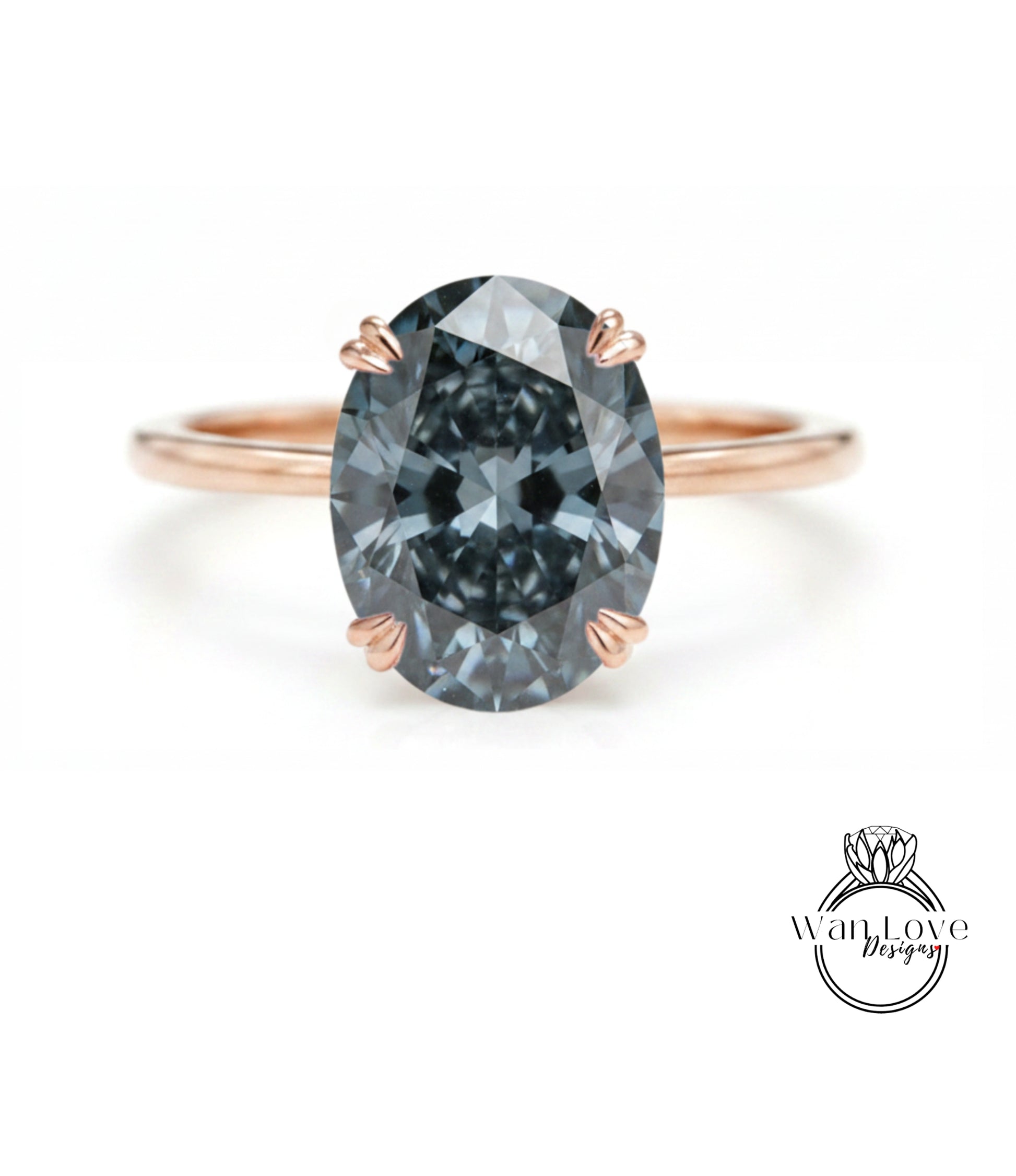 A close-up of a rose gold ring with a large, dark blue diamond as the centerpiece.