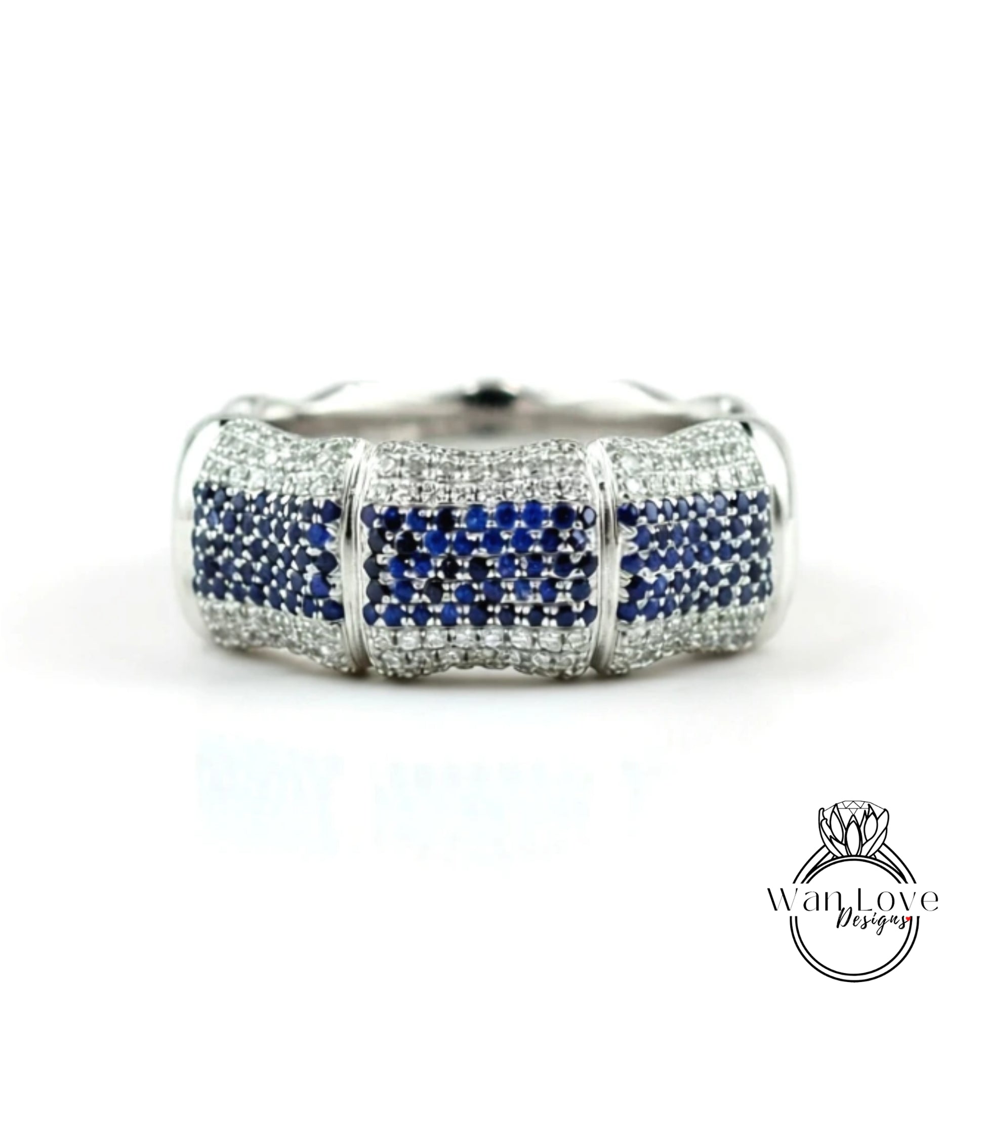 A silver ring with a blue gemstone design, featuring a repeating pattern of blue and white stones.