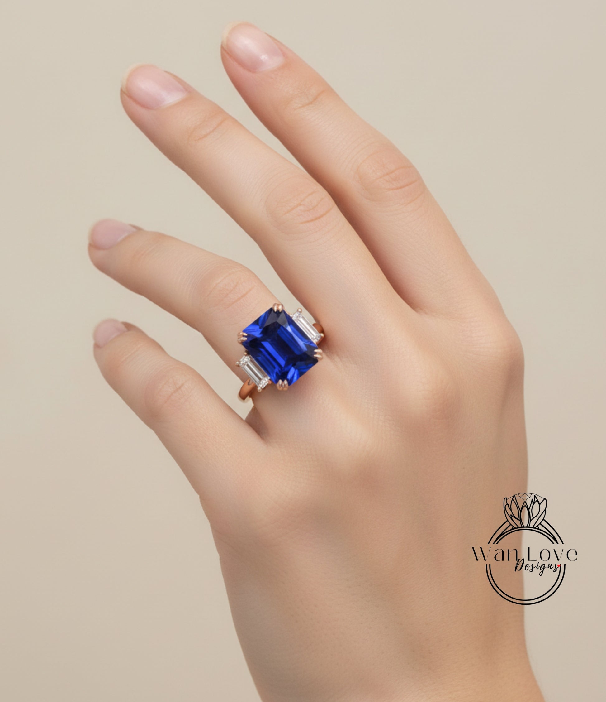 A close-up of a hand wearing a large blue gemstone ring with a gold band.