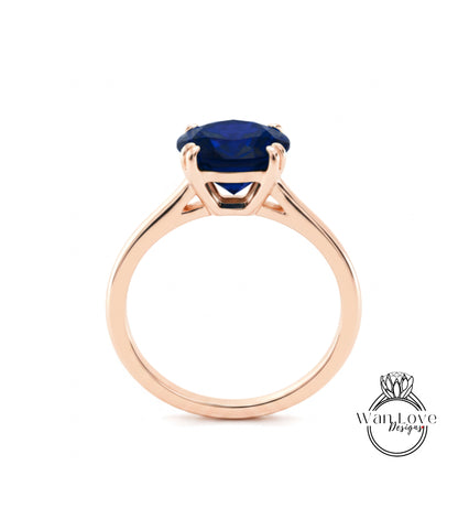 A gold ring with a large blue gemstone set in the center.