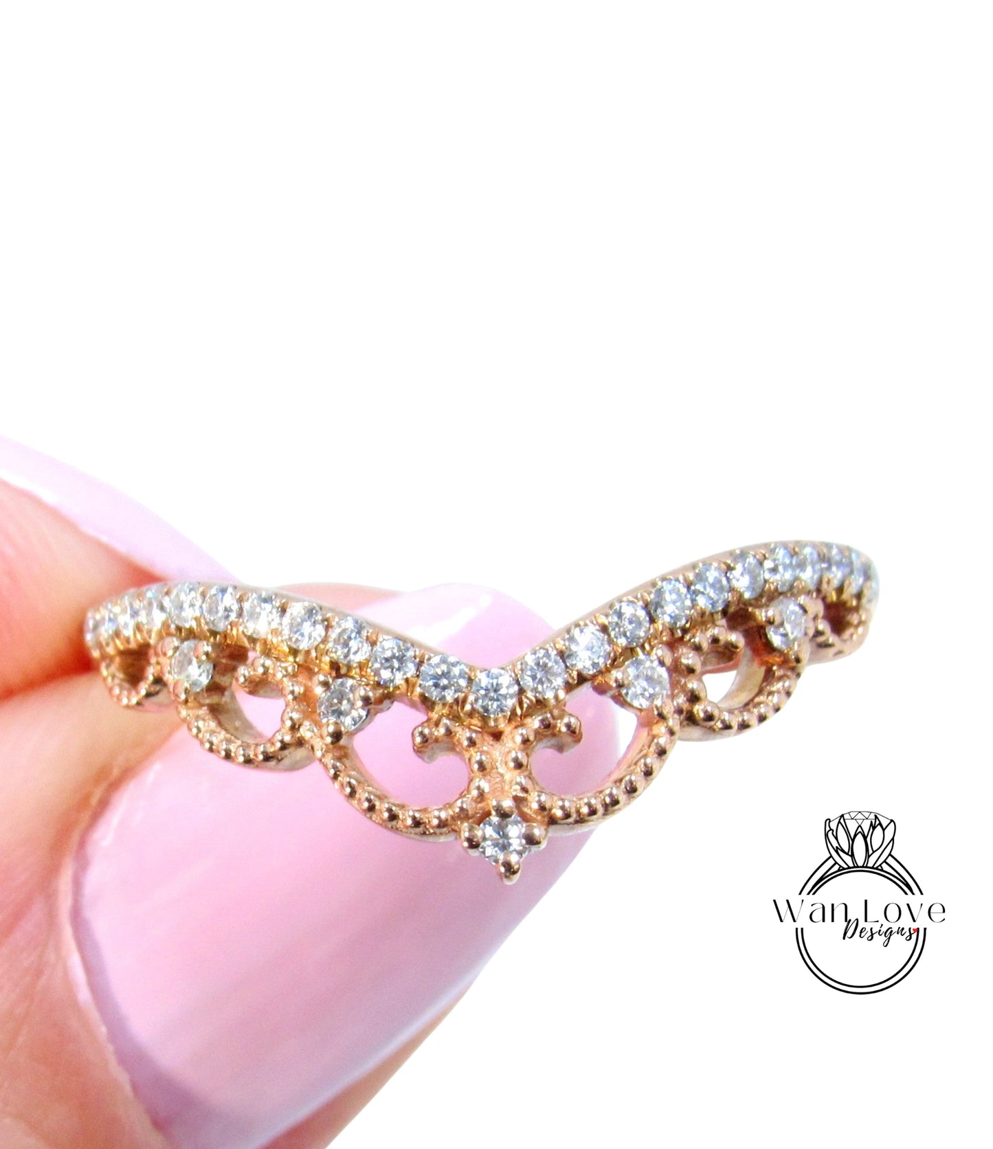 A close-up image of a gold ring with a decorative band featuring small diamonds.