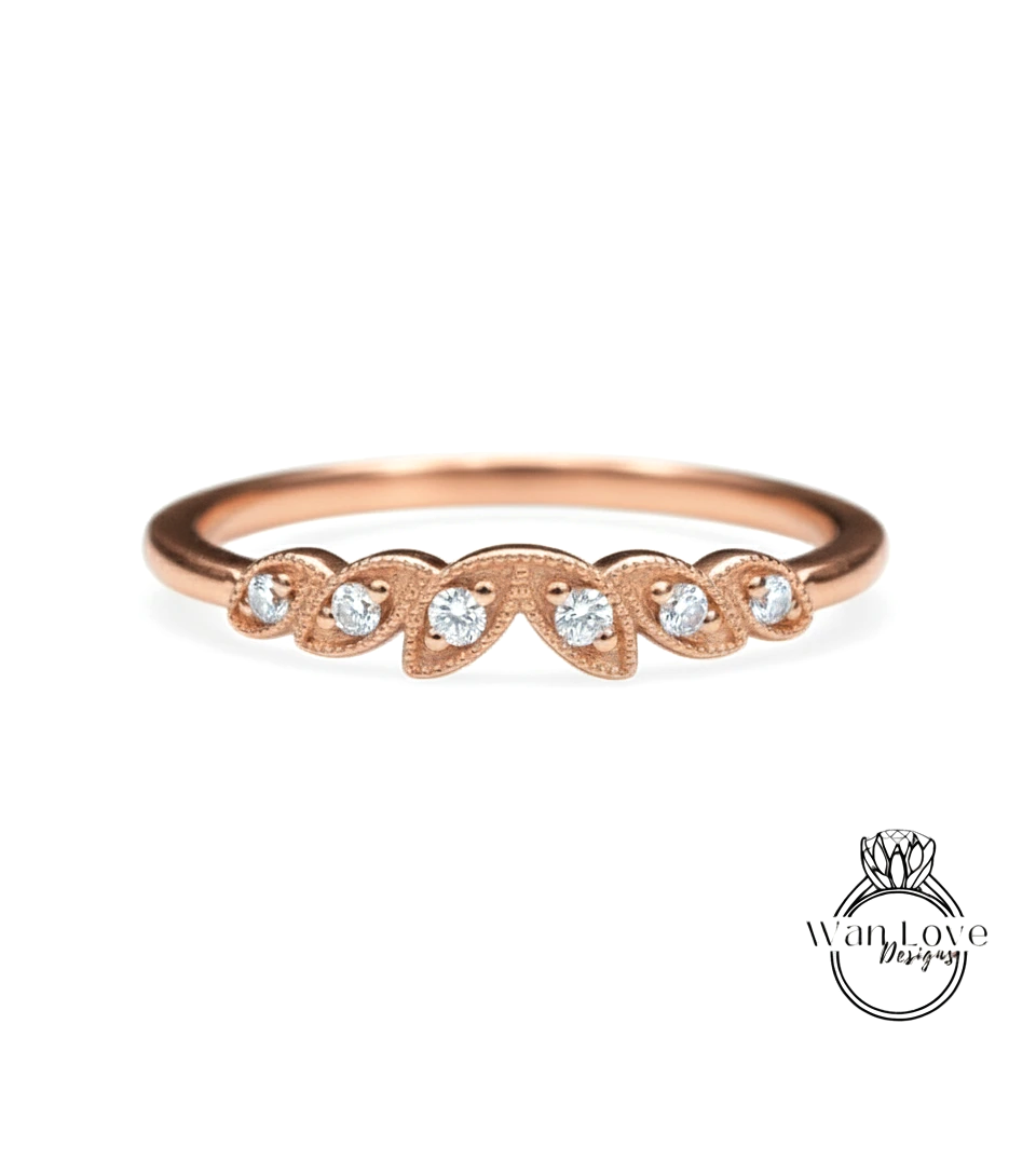 A rose gold ring with a row of small diamonds set in the center.