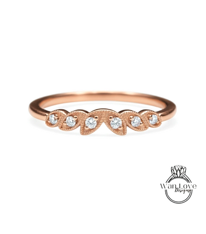 A rose gold ring with a row of small diamonds set in the center.