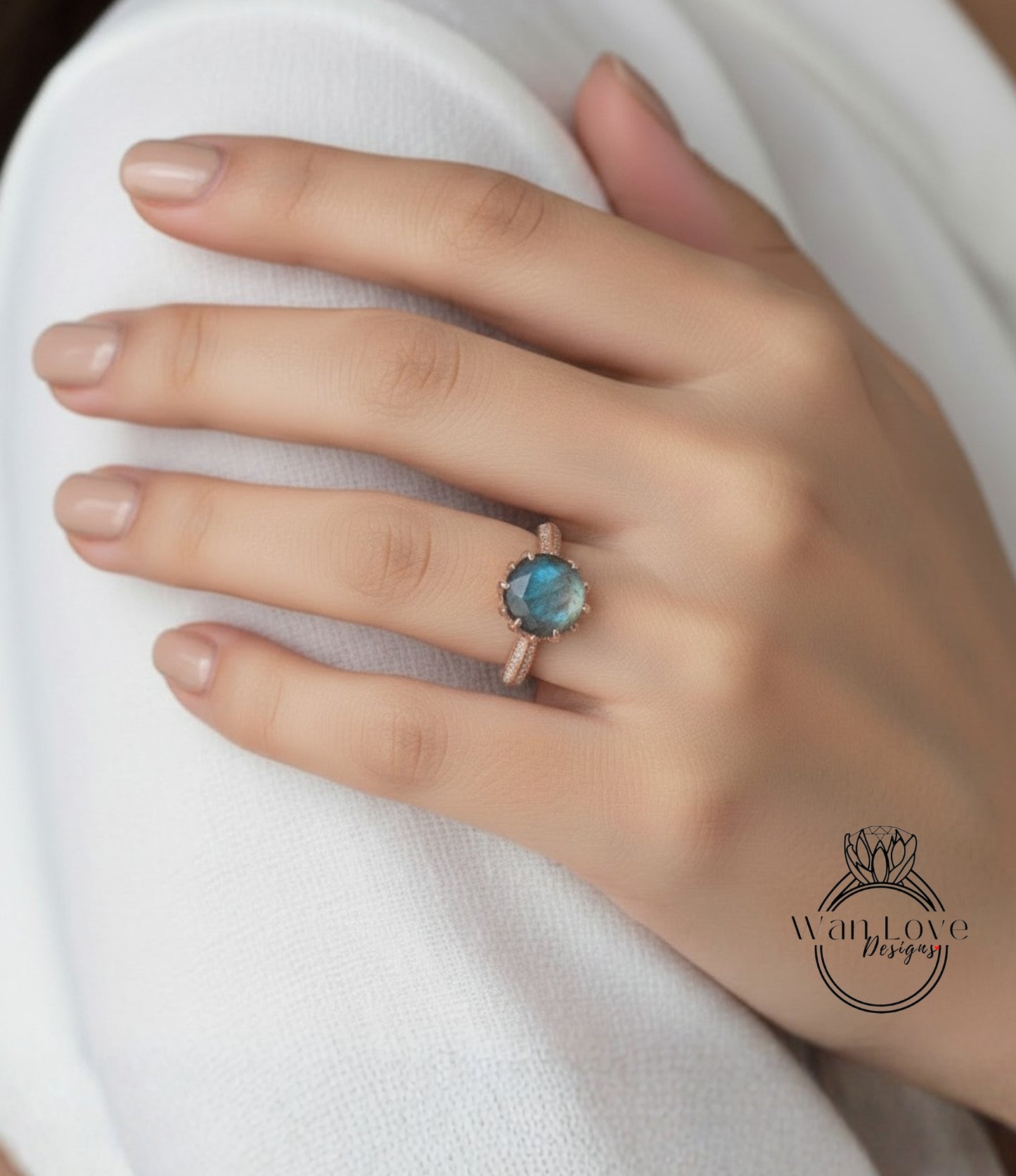 A close-up of a person's hand wearing a ring with a blue gemstone.