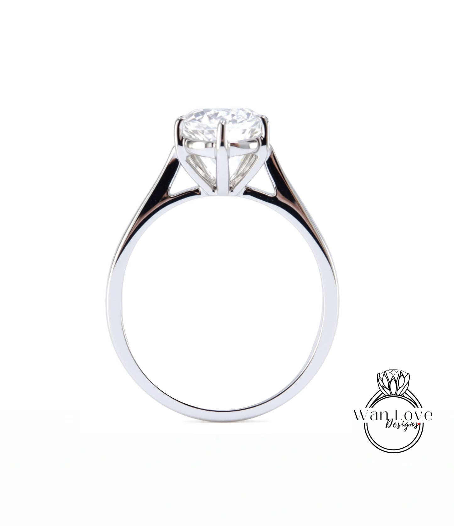 A close-up view of a silver engagement ring with a large diamond set in the center.