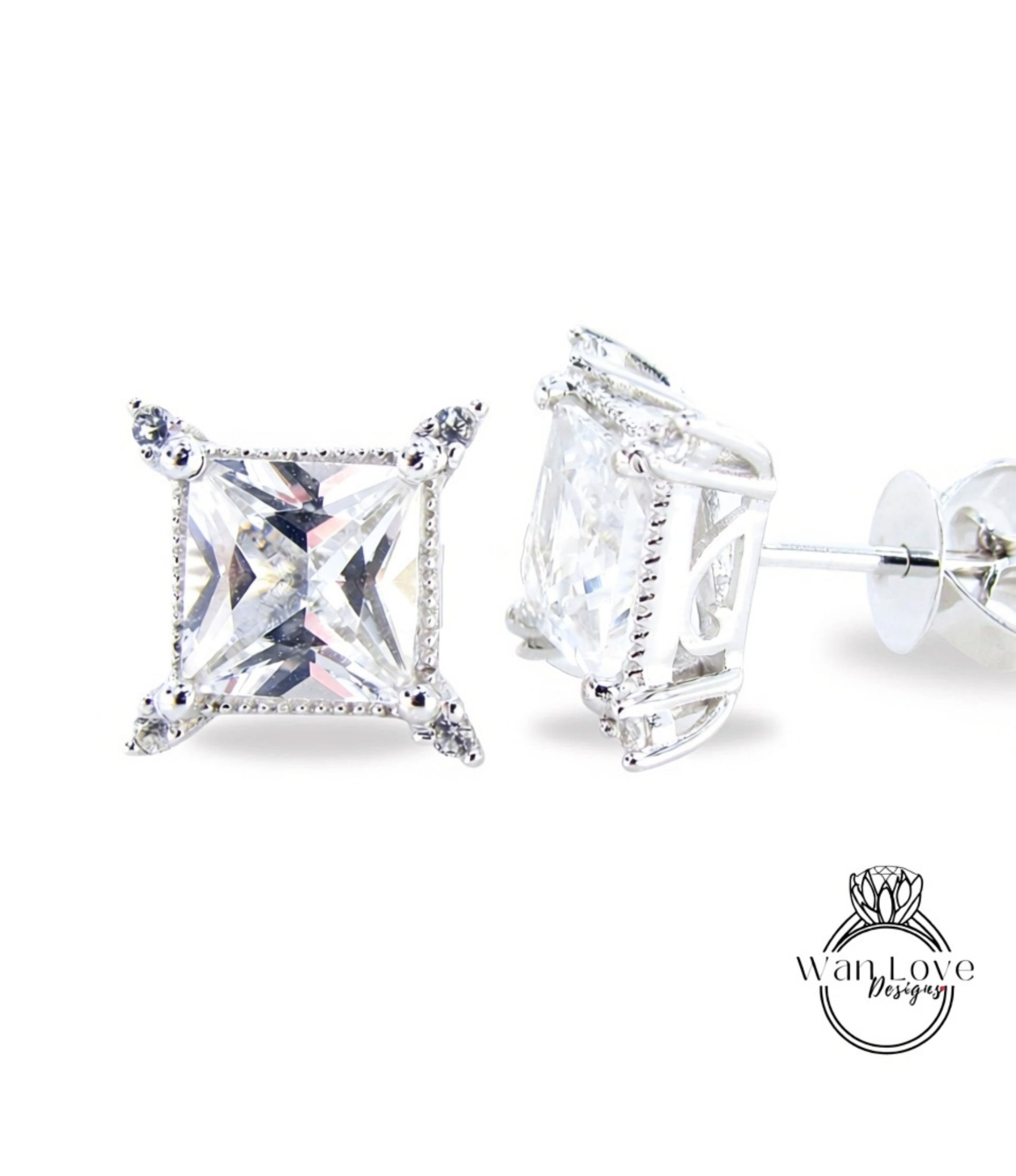 A pair of elegant diamond earrings with a large, clear gemstone set in a silver frame.