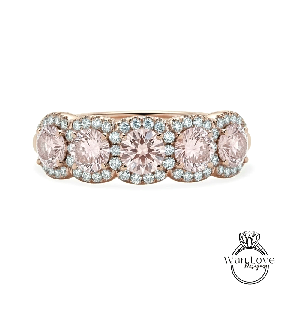 A gold ring with a row of pink gemstones set in the center, surrounded by smaller diamonds.