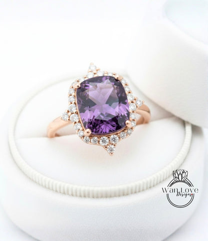 A close-up image of a beautiful ring with a large purple gemstone surrounded by smaller diamonds, placed in a white jewelry box.