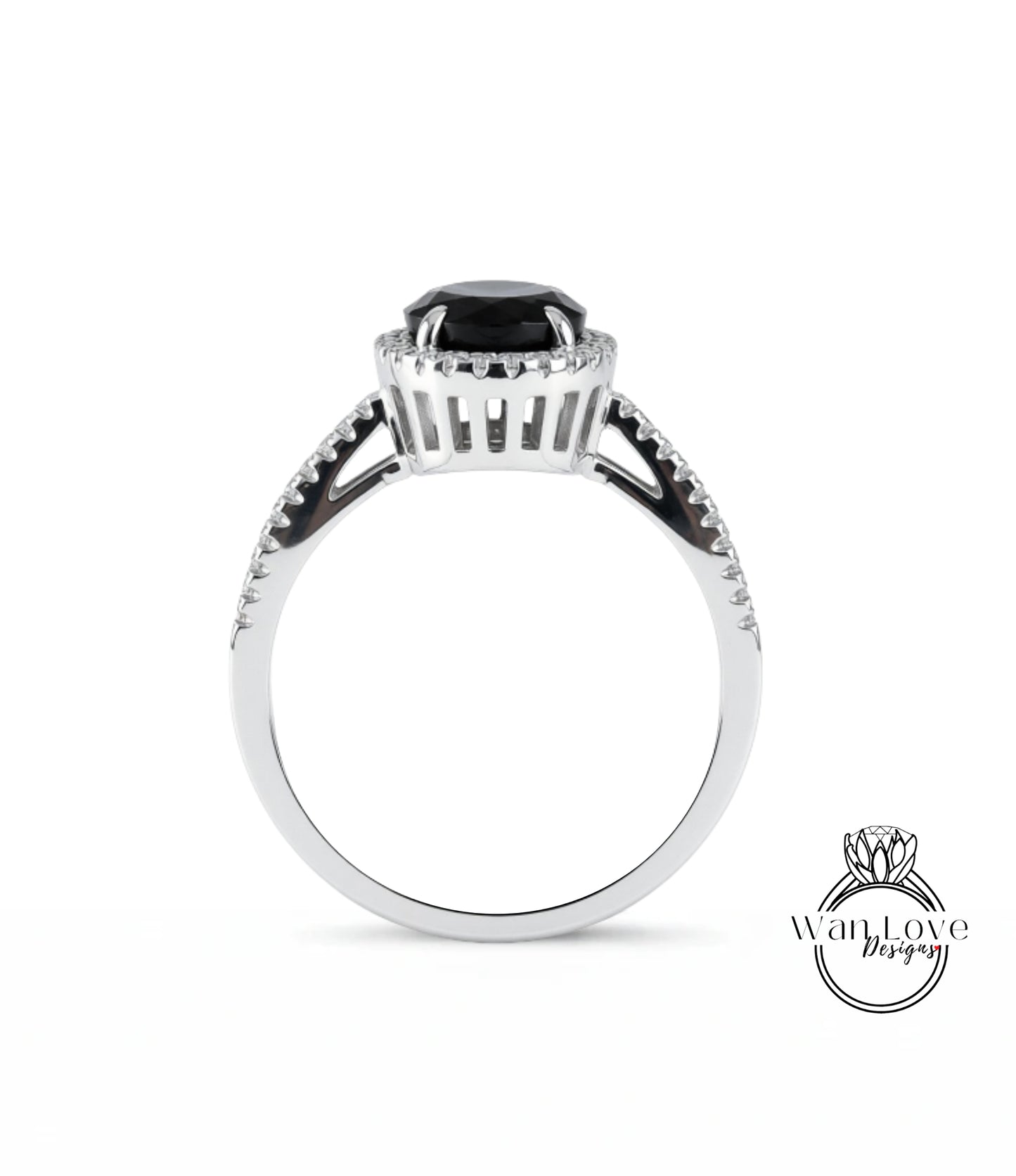 A silver ring with a large black gemstone, possibly a diamond, at the center.