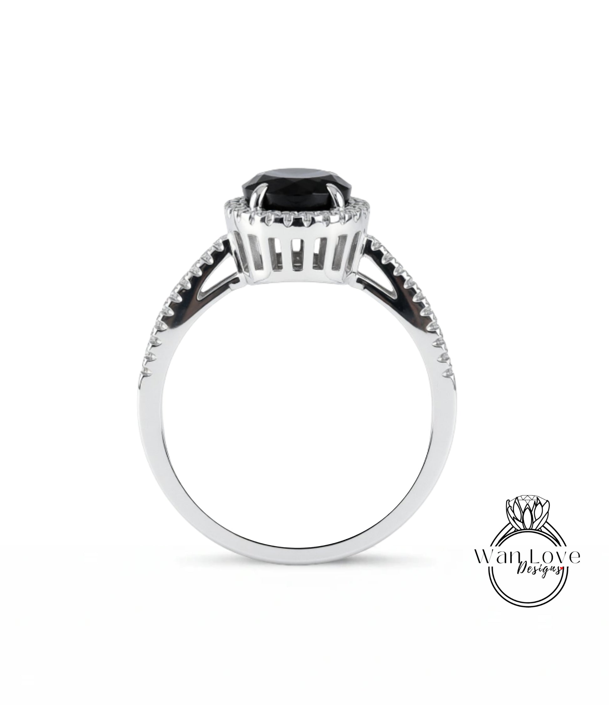 A silver ring with a large black gemstone, possibly a diamond, at the center.