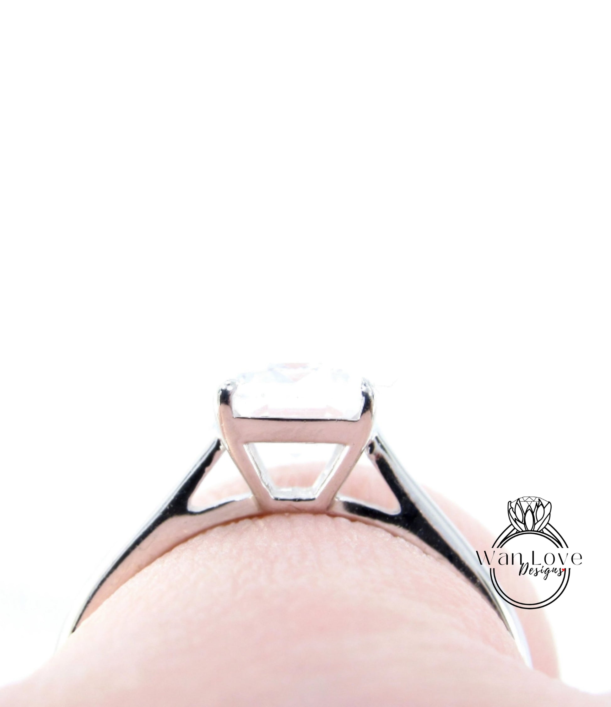 A close-up view of a silver engagement ring with a large diamond set in the center.