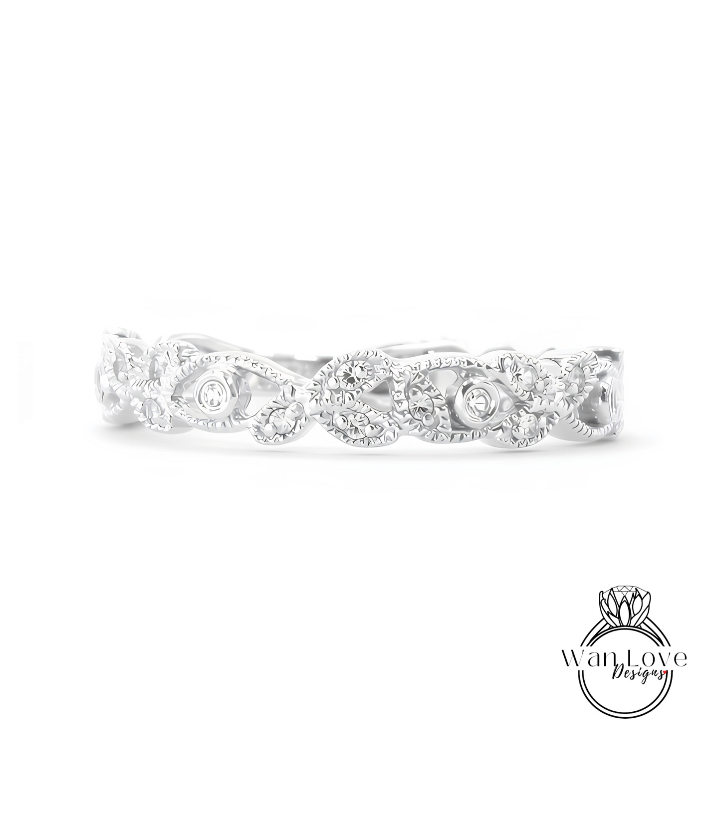 A silver ring with a decorative leaf design and small diamonds.