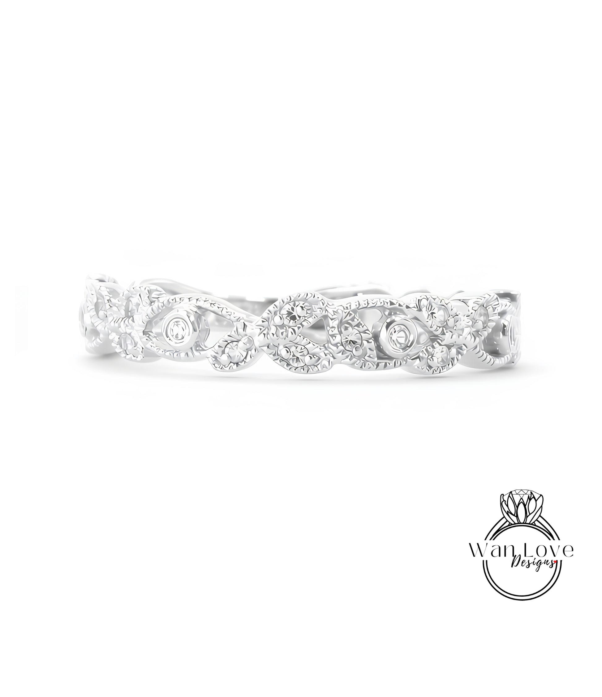 A silver ring with a decorative leaf design and small diamonds.