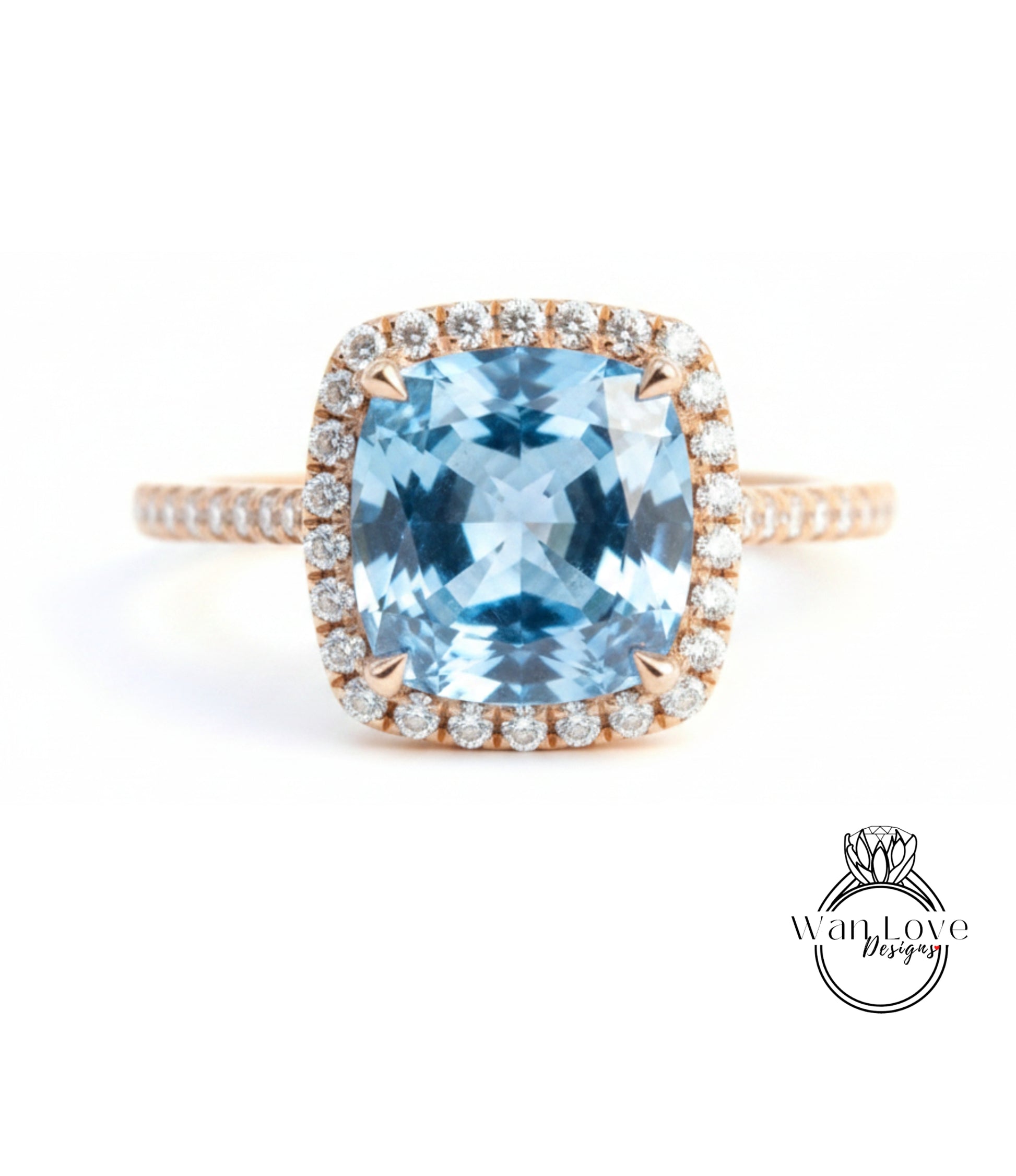 A stunning ring featuring a large, blue gemstone set in a halo of smaller diamonds, with a delicate gold band.