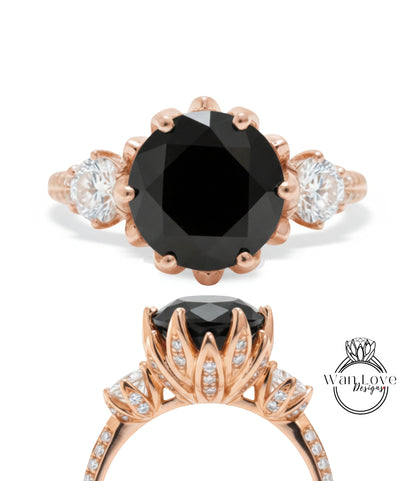 a beautiful engagement ring with a large black diamond as the centerpiece. The ring is adorned with a delicate floral design and is complemented by smaller diamonds on the band. The image showcases the ring from various angles, highlighting its intricate details and elegant design.