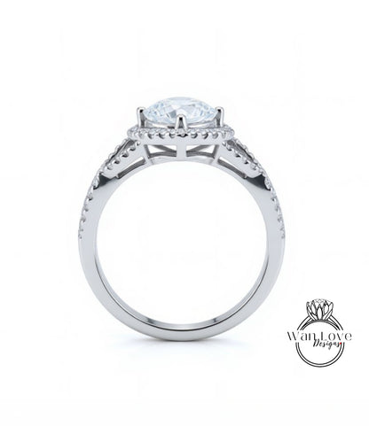 A silver engagement ring with a large central diamond and a halo of smaller diamonds around the center stone.