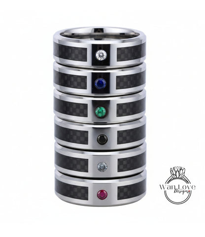 A stack of silver rings with gemstones, including a diamond and four different colored gemstones.