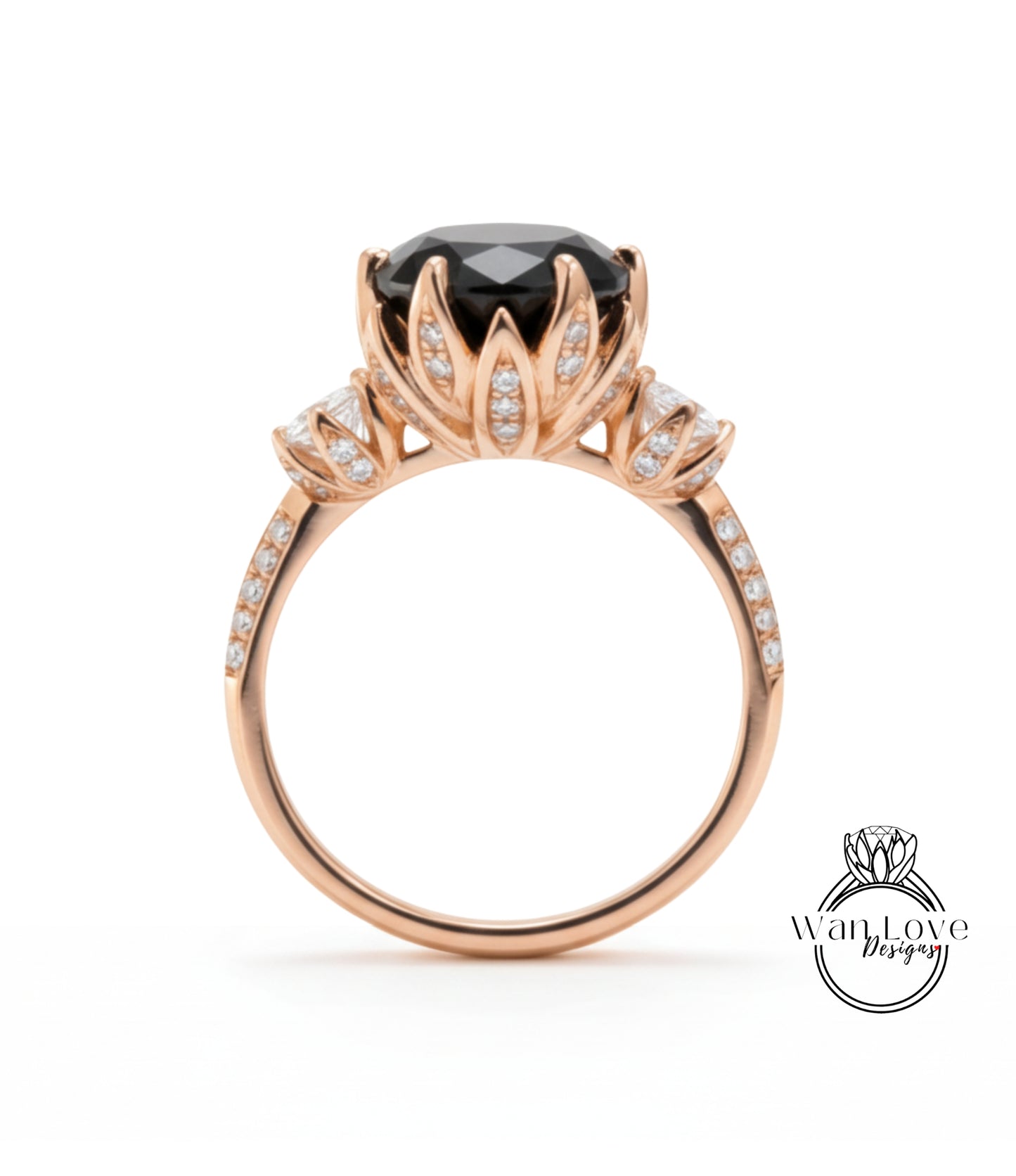 A gold ring with a large black gemstone, likely a diamond, at the center. The ring has a delicate floral design around the gemstone and is adorned with small diamonds.