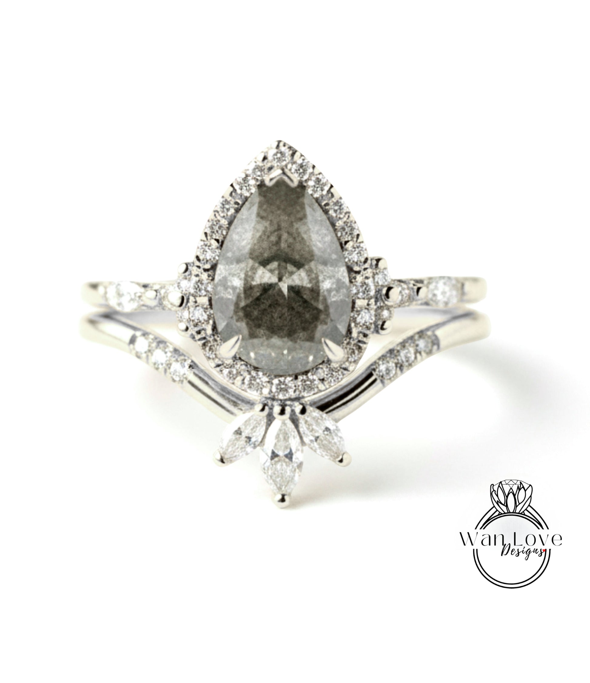 A close-up image of a diamond engagement ring with a large pear-shaped diamond at the center, surrounded by smaller diamonds and set in a halo of smaller diamonds.