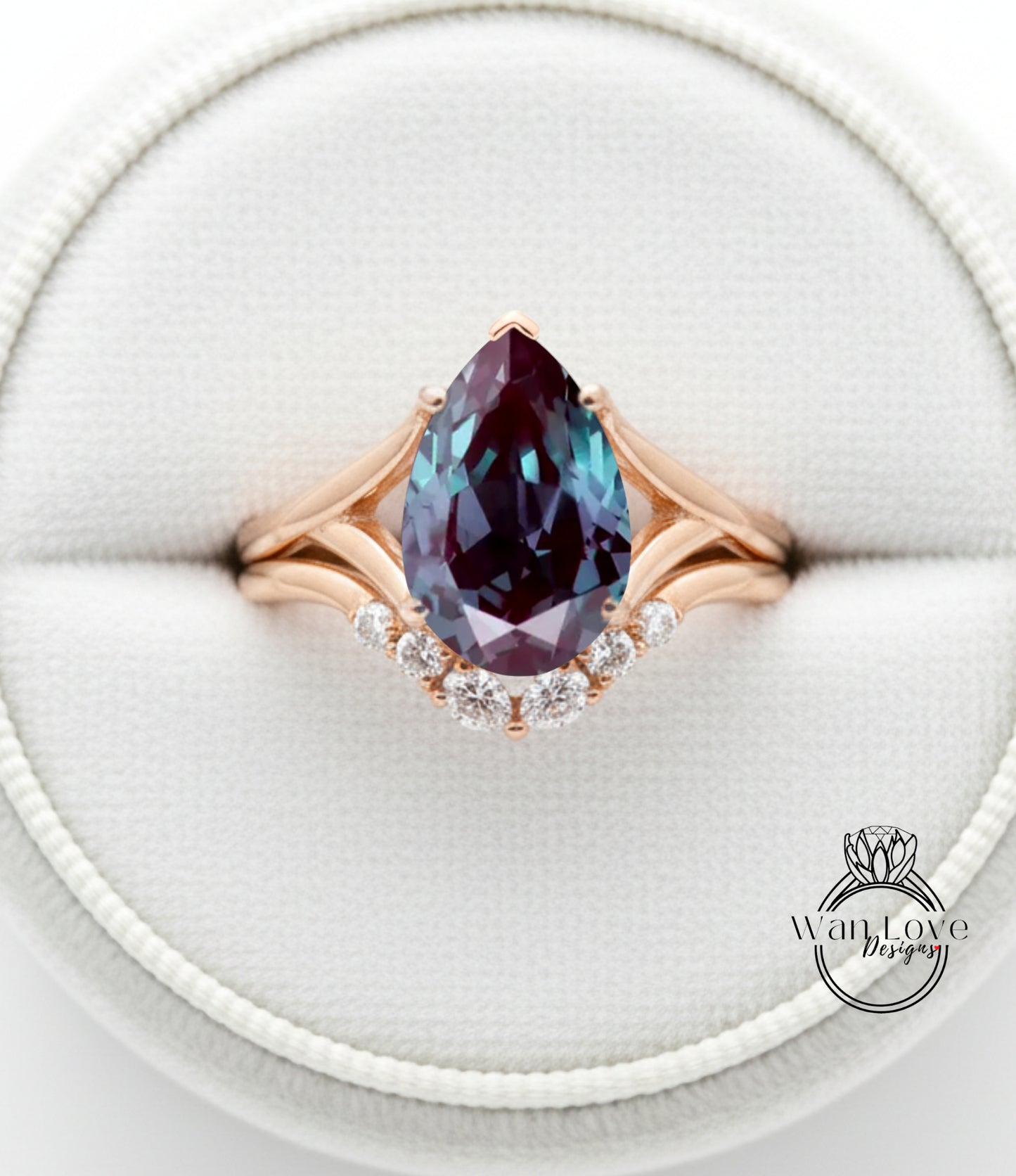 A close-up image of a gold ring with a large, deep blue gemstone, likely a pear-shaped gemstone, set in a diamond-encrusted band.