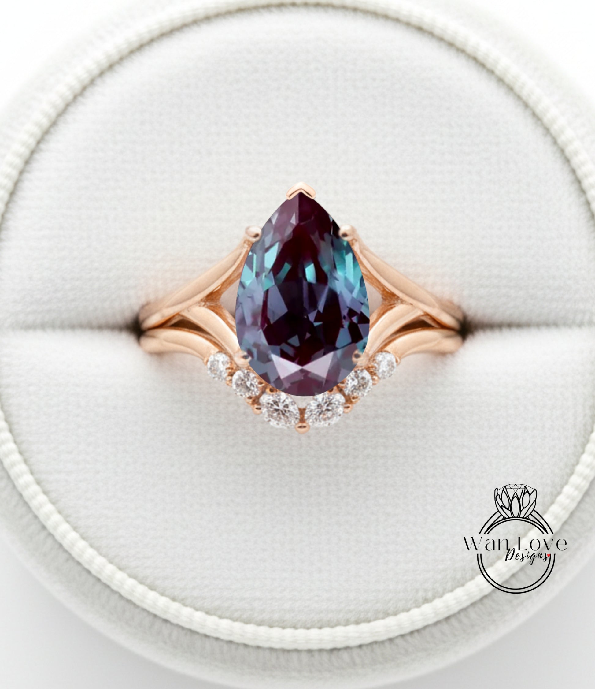 A close-up image of a gold ring with a large, deep blue gemstone, likely a pear-shaped gemstone, set in a diamond-encrusted band.