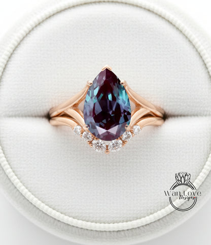 A close-up image of a gold ring with a large, deep blue gemstone, likely a pear-shaped gemstone, set in a diamond-encrusted band.