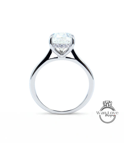 A silver engagement ring with a large diamond set in the center, showcasing the intricate design and craftsmanship of the jewelry piece.