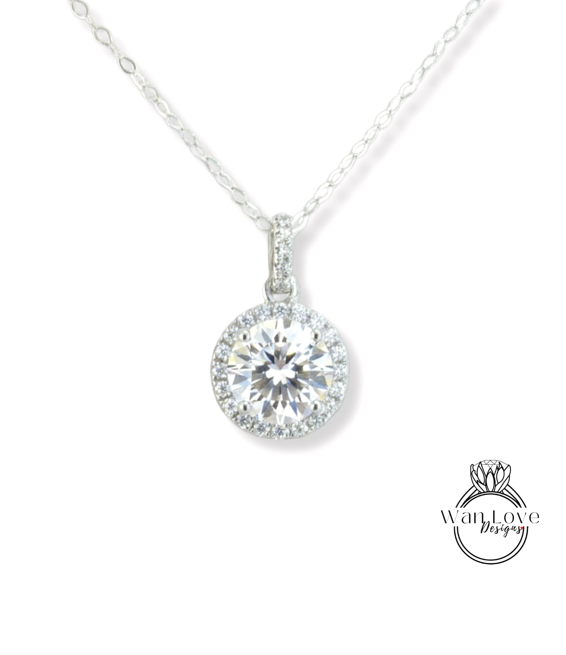 A necklace with a large, round diamond pendant hanging from a chain.