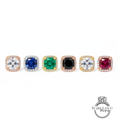 A row of six diamond-encrusted earrings with various colored gemstones, including blue, green, black, and red diamonds.